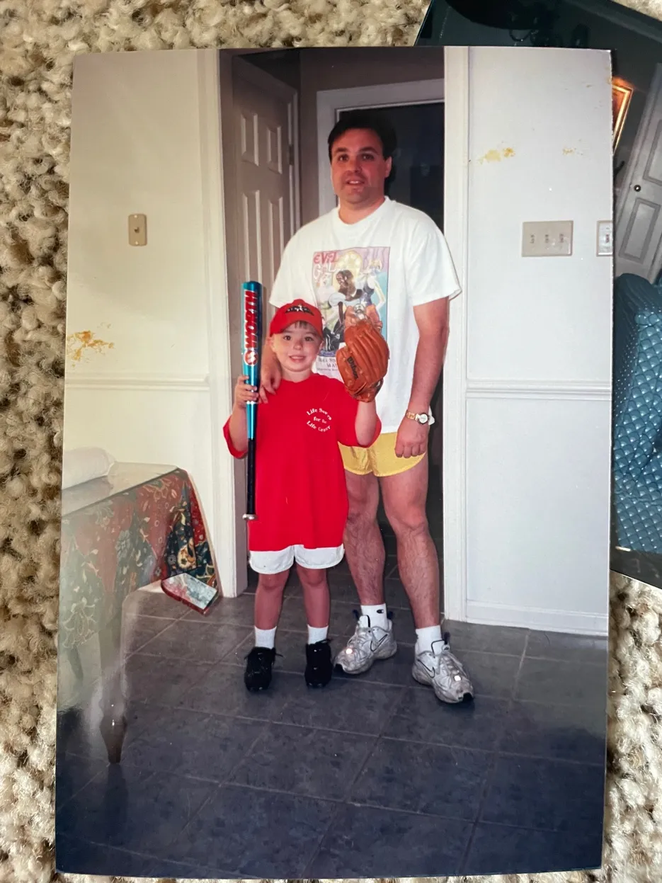 Young Austin with his dad, bat and glove in hand